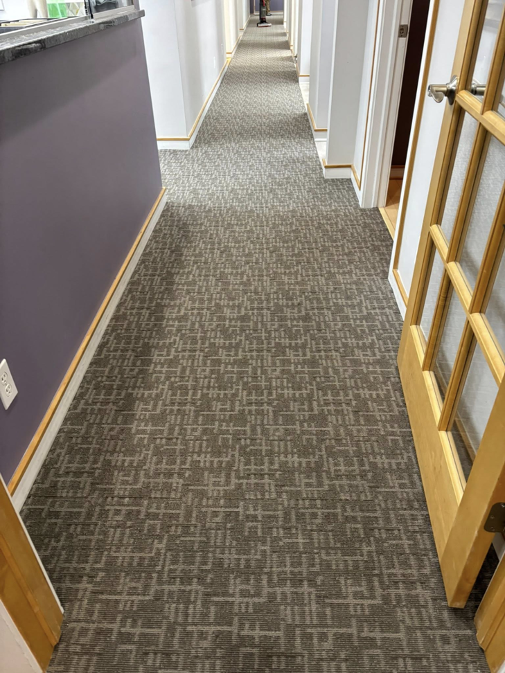 A long hallway featuring a new patterned carpet installation by Carpet Near Me, available in Services Available In.