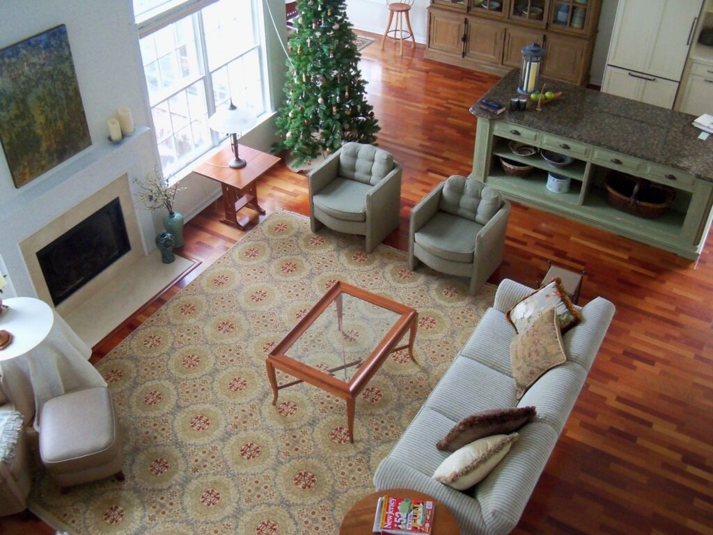 A large patterned rug defining an open-plan living room and kitchen area, a project by Brandon Oriental Rugs in Furlong, PA.