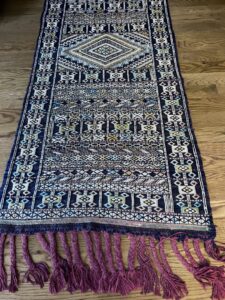 A beautifully patterned rug runner displayed on a hardwood floor from Rug Masters in Charleston, SC.