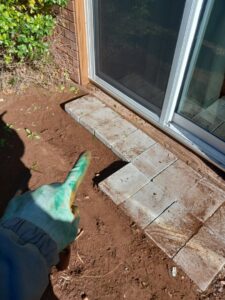 Pavers being installed for a patio or walkway next to a house by A & A Lawn Care Service LLC in Moore, OK.