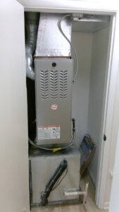 A Payne brand furnace and air handler unit installed in a utility closet by Basic HVAC in Indianapolis, IN.