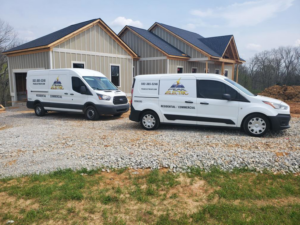 Two Peak Electric vans parked at a new construction site in Mount Washington, KY, ready for electrical installation.