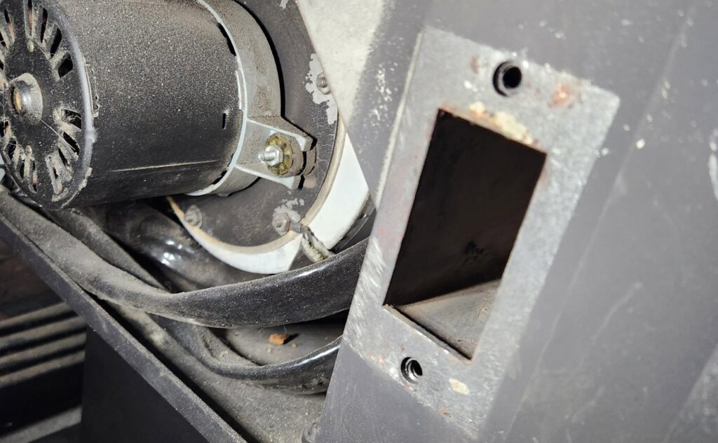 Close-up of pellet stove internal components during maintenance by Top Dog Hearth Repair & Maintenance, LLC in Worcester, MA