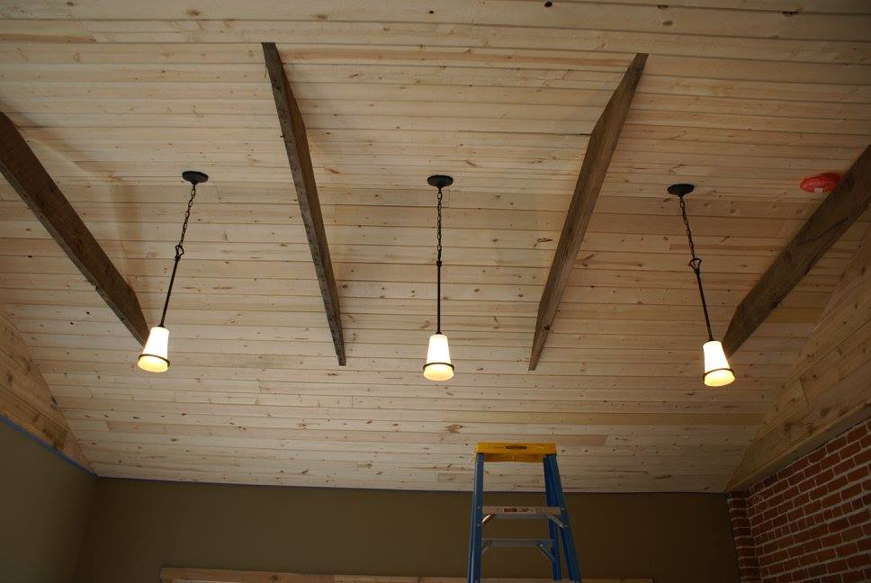 Pendant light installation on a wooden ceiling, indicating electrical work by Accuracy Electric Incorporation in Lakewood, CO.