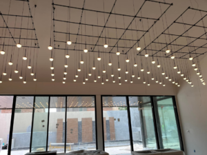 A ceiling with a complex grid of numerous pendant lights installed by Krajcer Electric in New Orleans, LA