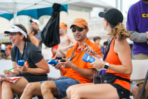People operating timing devices at an aquatic event, showcasing services by Colorado Time Systems in Loveland, CO.