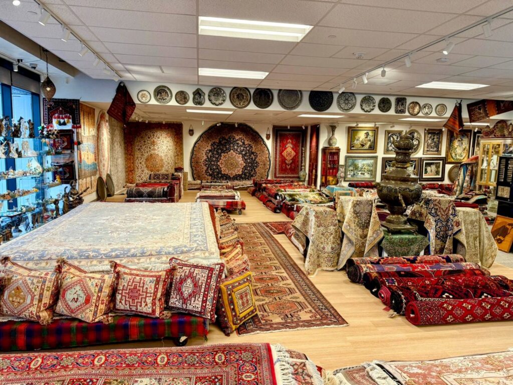 A wide view of the Art Of Persia showroom displaying numerous beautiful Persian rugs and carpets in Portland, OR.