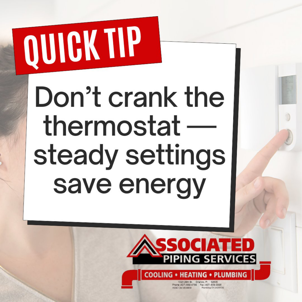 A person adjusting a thermostat for energy efficiency at a property served by Associated Piping Services in Orlando, FL.