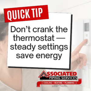 A person adjusting a thermostat for energy efficiency at a property served by Associated Piping Services in Orlando, FL.