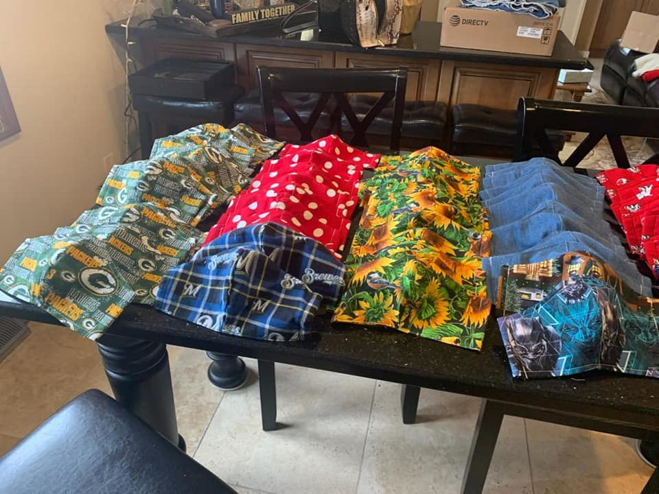 A person in yellow boots using a professional machine to clean a large oriental rug at Dave's Magikist, Inc. in Milwaukee, WI.