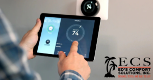 A person controlling a smart thermostat with a tablet, demonstrating modern HVAC control from Ed's Comfort Solutions, Inc in Callahan, FL.