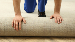 A person unrolling new carpet for installation by Soto Provider Services in Millcreek, UT