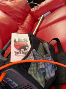 A pest control backpack sprayer and brochure for Ladybug Services, ready for a job in Westfield, NJ.