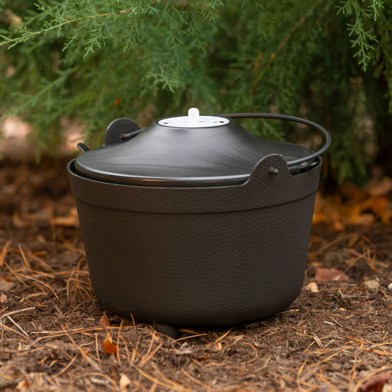 A black pest control bait station placed on the ground by Stuck in Lancaster, PA.