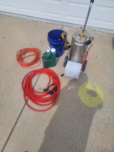 Various pest control equipment, including a sprayer and hoses, ready for a job by KC Pest Experts in Olathe, KS.