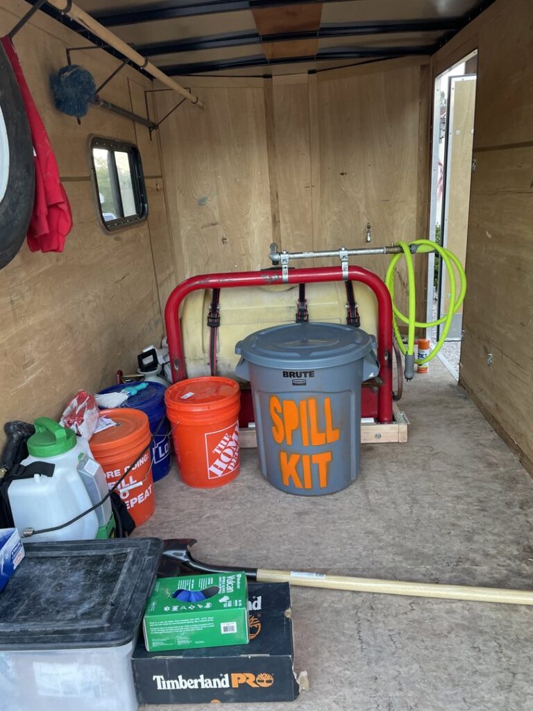 Pest control equipment, including a sprayer and spill kit, inside a service trailer for Reliable pest control solutions in Hannibal, MO