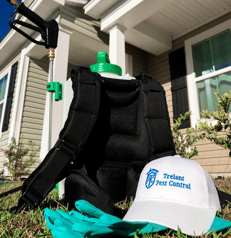 Pest control equipment, including a backpack sprayer, gloves, and Trelant Pest Control hat, ready for service in Charleston, SC.