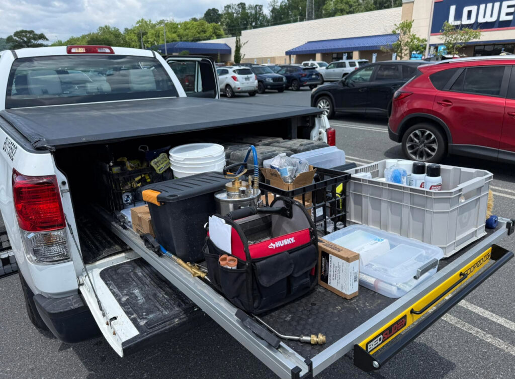 A truck bed loaded with various pest control equipment and supplies for Devlins Pest Control in Reading, PA.