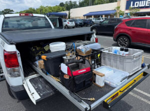 A truck bed loaded with various pest control equipment and supplies for Devlins Pest Control in Reading, PA.