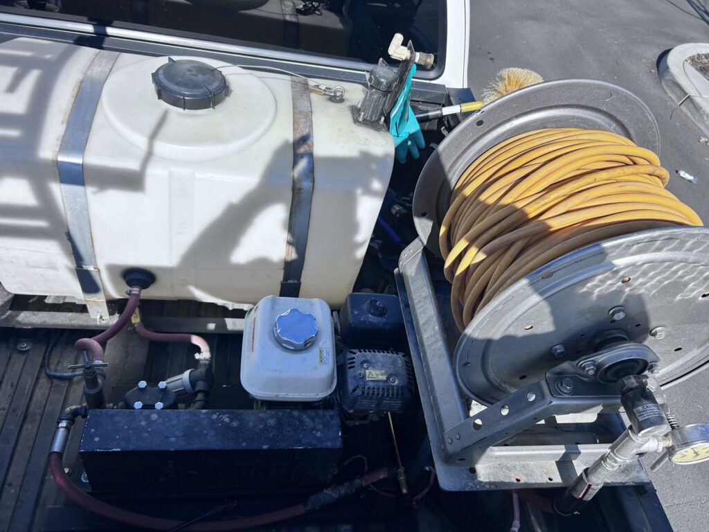 Pest control equipment, including a tank and hose reel, in a Dan's Pest Management truck in Bakersfield, CA