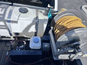 Pest control equipment, including a tank and hose reel, in a Dan's Pest Management truck in Bakersfield, CA