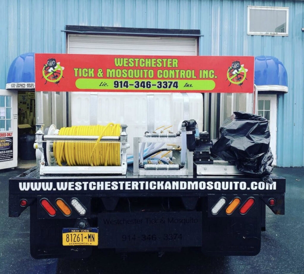 Close-up of pest control equipment, including hoses and tanks, on a Westchester Tick and Mosquito Control truck in New Rochelle, NY.