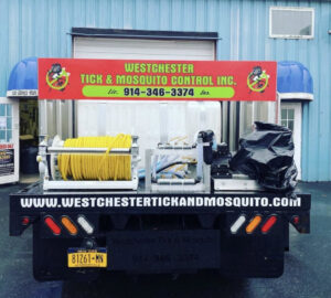 Close-up of pest control equipment, including hoses and tanks, on a Westchester Tick and Mosquito Control truck in New Rochelle, NY.