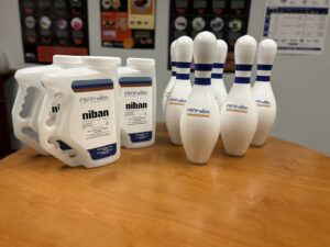Niban granular bait and Perimetek branded bowling pins, representing pest control products in East Syracuse, NY.