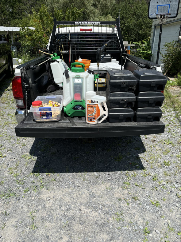 Close-up of Sheridan Pest Control truck bed with Niban bait, sprayer, and rodent stations in Albany, NY.