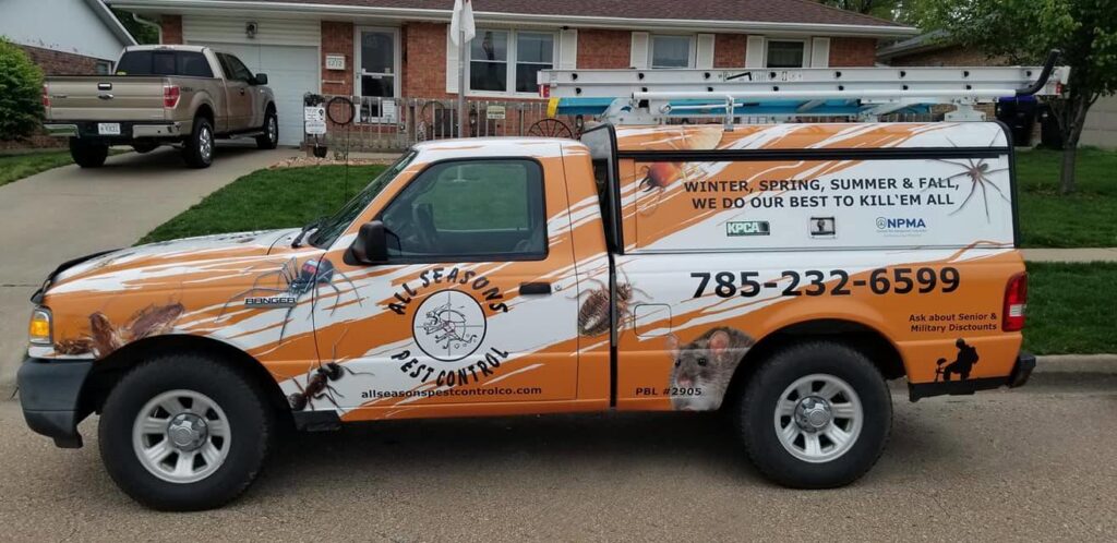 A branded pest control service truck from All Seasons Pest Control LLC parked in front of a home in Topeka, KS.