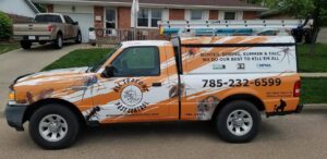 A branded pest control service truck from All Seasons Pest Control LLC parked in front of a home in Topeka, KS.
