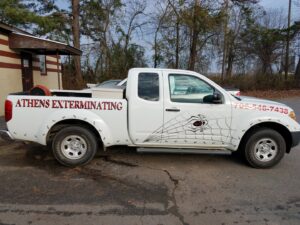 A white pest control service truck with Athens Exterminating branding in Athens, GA