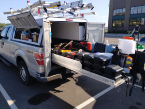 A Kingdom Pest Control & Services truck in Brooklyn Park, MN, loaded with equipment for a wildlife and pest control job.