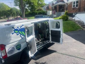 An EcoPro Termite & Pest service van with open doors, showing pest control equipment inside, in Dayton, OH