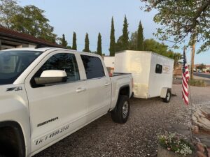 A service truck and trailer from Reliable pest control solutions parked at a residential property in Hannibal, MO