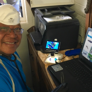 A pest control specialist from Da Bug Doctor in Hilo, HI, identifying insects using a digital microscope and laptop.