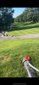 A pest control sprayer nozzle applying treatment to a grassy area by Metro Pest Solutions in West Des Moines, IA.