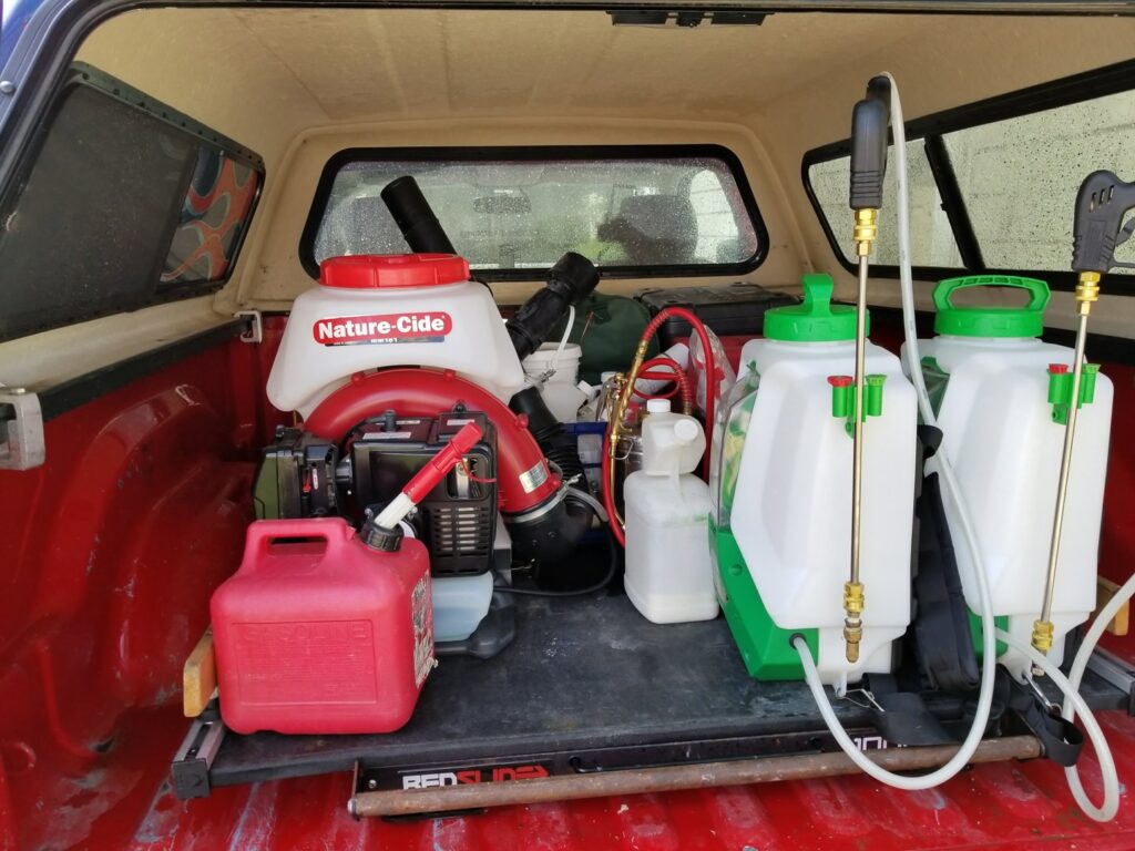 Various pest control sprayers and equipment organized in the back of a service truck for Spectrum Pest Control Eco-Tech LLC in Kenosha, WI.