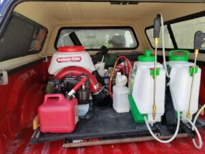 Various pest control sprayers and equipment organized in the back of a service truck for Spectrum Pest Control Eco-Tech LLC in Kenosha, WI.
