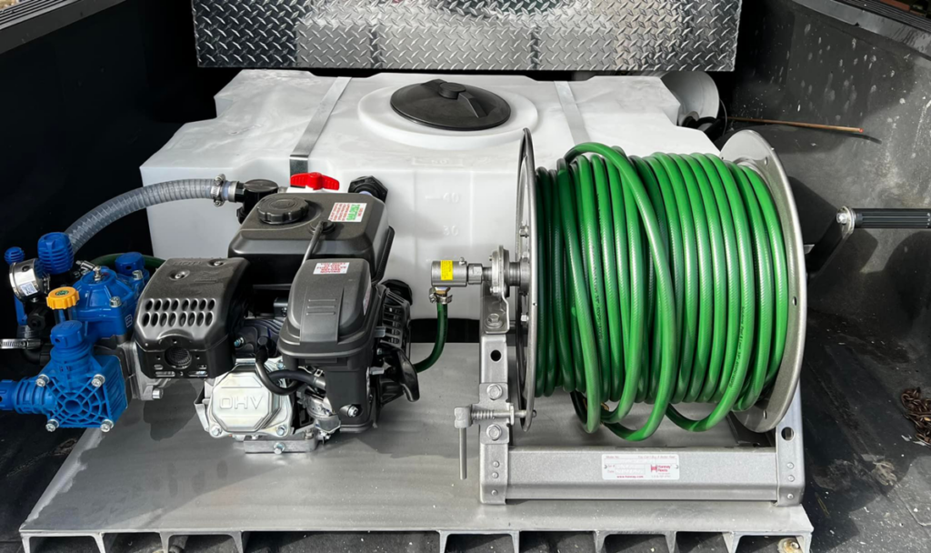 Pest control spraying equipment with a large tank and hose reel in a truck bed for Vanguard Pest Solutions in Oklahoma City, OK