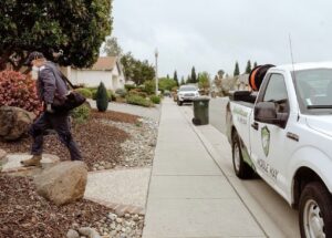 A pest control technician from The Noble Way Pest Control arriving at a residential home in Sacramento, CA.