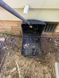 A pest control technician wearing a protective bee suit next to a ClearCut Pest Control Inc. truck in High Point, NC.