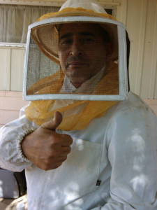 A pest control technician in a beekeeper suit giving a thumbs-up, representing A. Pest Specialist LLC in Glendale, AZ.