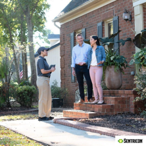 A Permatox Pest Control technician consulting with clients outside their home in Shreveport, LA