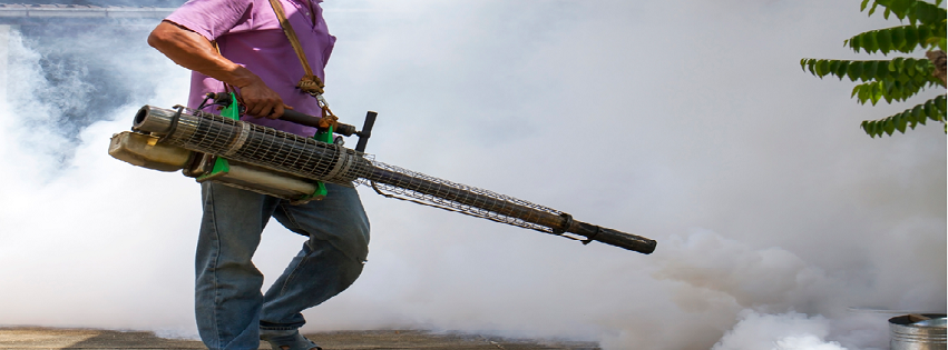 A pest control technician fogging an outdoor area for mosquitoes and other pests at Advanced Pest Control Solutions in Youngstown, OH.