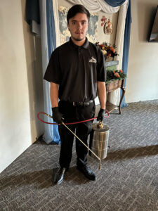 A pest control technician from Eagle Eye Extermination performing an indoor treatment in Kalispell, MT.