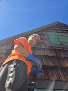 A Pony Express Pest Control technician inspecting the exterior of a building for pests in Pollock Pines, CA.