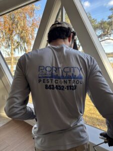 A Port City Pest Control technician inspecting a home interior during a pest control service in Summerville, SC.