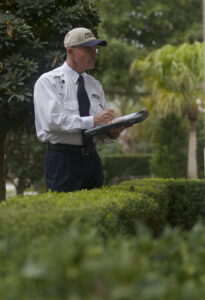 A Massey Services, Inc. pest control technician inspecting a property and taking notes in Melbourne, FL.