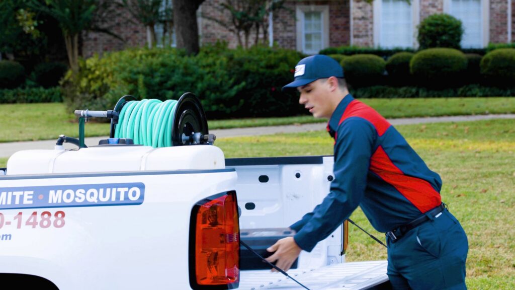 A Fox Pest Control technician loading equipment into a company truck in Glen Ellyn, IL